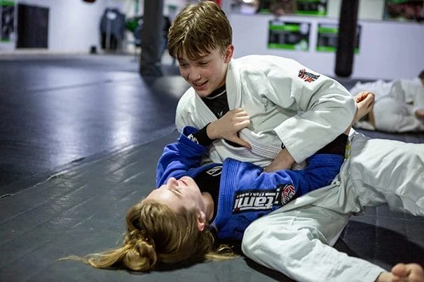 Boy and a girl sparring Jiu-Jitsu